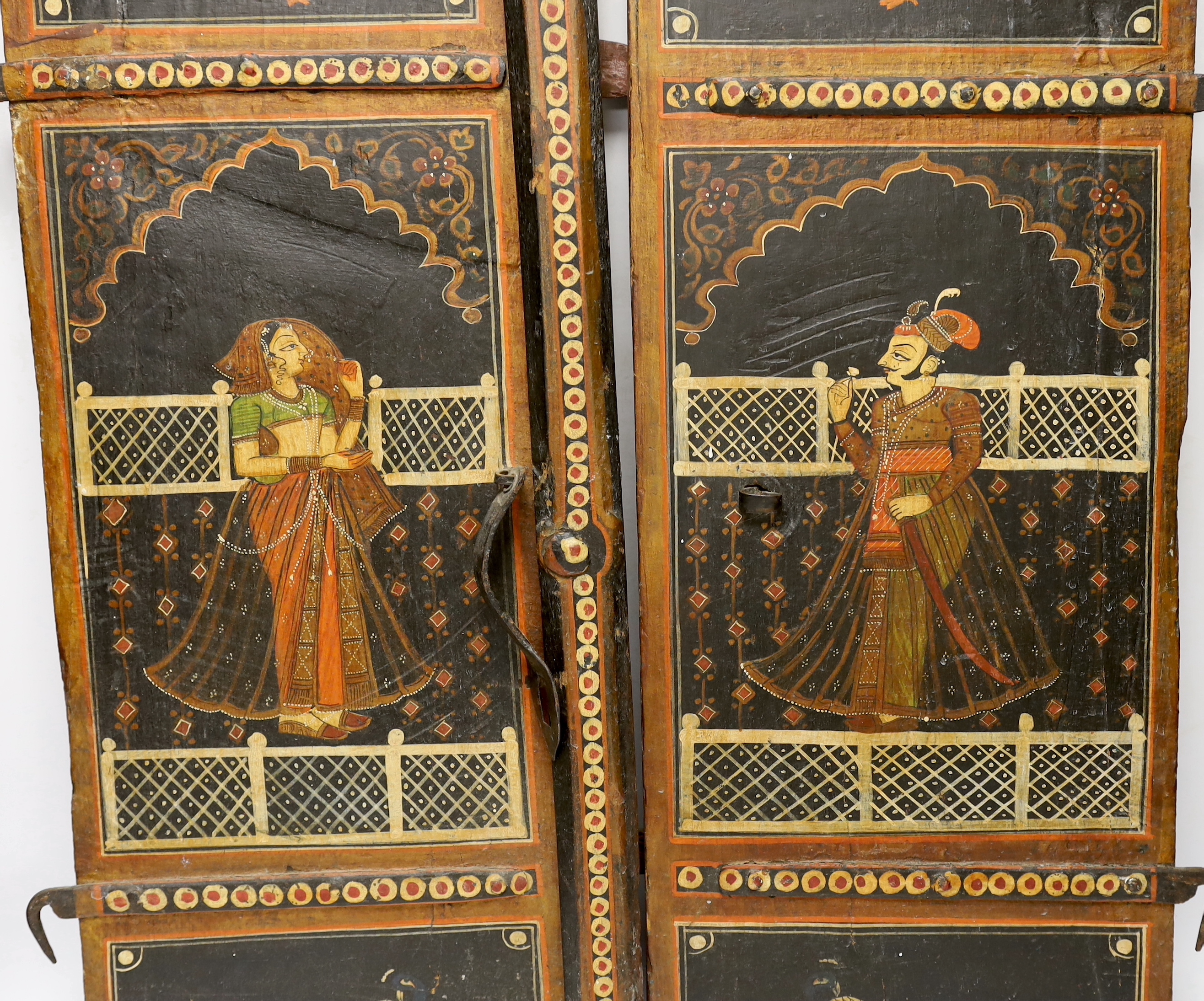 A pair of painted Indian shutters hand painted with figures and birds, 67cm high